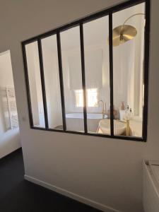 a bathroom with a large window in a room at A Casa Di Rose in Ajaccio