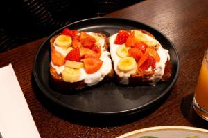 two pieces of toast with fruit on a black plate at Miller & Carter Aughton by Innkeeper's Collection in Ormskirk +19 photos