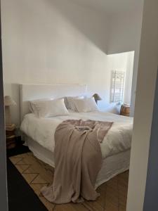 a bedroom with a white bed with a blanket on it at A Casa Di Rose in Ajaccio +15 photos