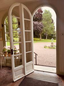 an open door to a yard with a park at Munkedals Herrgård in Munkedal +99 photos