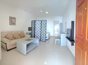 a living room with a couch and a table at SunSea Resort in Guimaras