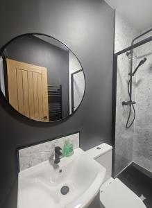 a bathroom with a white sink and a mirror at The Quay Corner in Saint Thomas Station