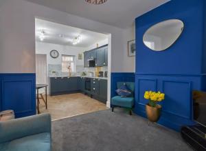 a kitchen with blue cabinets and a blue wall at The Quay Corner in Saint Thomas Station +22 photos