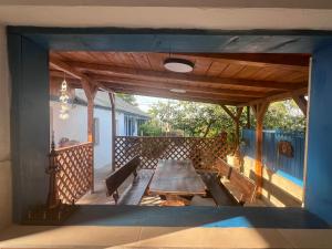 a wooden table on the back porch of a house at Casa Albastra in Mahmudia