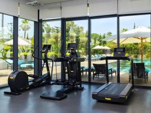a gym with cardio equipment and a swimming pool at STORY Rabat in Rabat