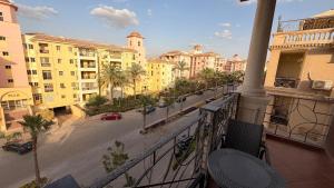 a balcony with a view of a street and buildings at Dream Royal Residence in 6th Of October