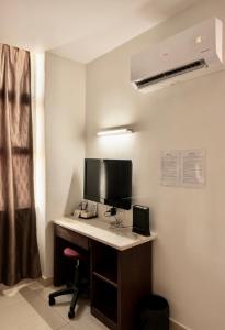 a room with a desk with a computer on it at New century inn in Bintulu