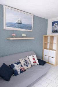 a room with a bed with a sailboat on the wall at Le VALLON à POR-NIC in Pornic +25 photos