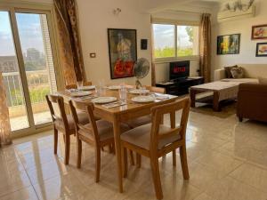 a dining room table and chairs in a living room at Maison de Lama - Expat friendly, AirCon, Garden access in Cairo