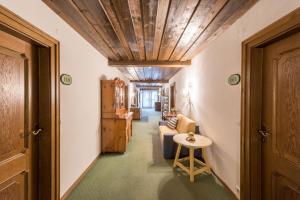 a hallway with a room with a couch and a table at Hotel Gasthof Bräuwirth in Bergheim