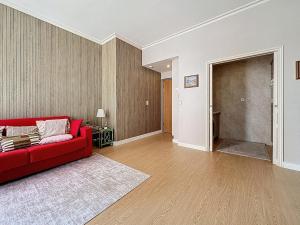 a living room with a red couch and a hallway at Sea View 2BR 2BA - 4 min Palais - Ideal Cannes Film Festival Stay in Cannes
