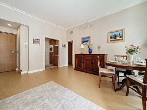 a living room with a table and a dining room at Sea View 2BR 2BA - 4 min Palais - Ideal Cannes Film Festival Stay in Cannes