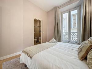 a bedroom with a large white bed and a window at Sea View 2BR 2BA - 4 min Palais - Ideal Cannes Film Festival Stay in Cannes +20 photos