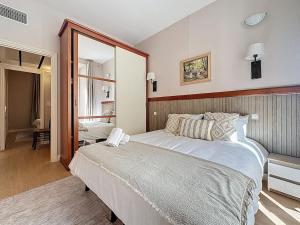 a bedroom with a large bed and a large mirror at Sea View 2BR 2BA - 4 min Palais - Ideal Cannes Film Festival Stay in Cannes