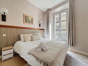 a bedroom with a large white bed with a window at Sea View 2BR 2BA - 4 min Palais - Ideal Cannes Film Festival Stay in Cannes