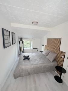 a bedroom with a large bed with a black cross on it at Robert in Verdun-sur-Meuse