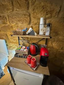 a table with a coffee maker and cups on it at b&b centro città in Agrigento