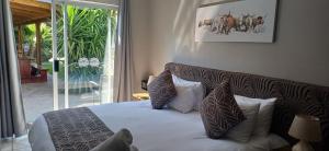 a bedroom with a bed with pillows on it at Potties Guesthouse in De Aar +33 photos