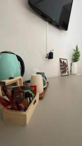 a table with a box and a tv on a wall at Hotel Del Corso in Bibione