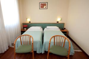 Postel nebo postele na pokoji v ubytování Hotel Valbrenta