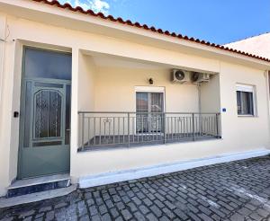 a house with a balcony with a fan at Radio House in Myrina