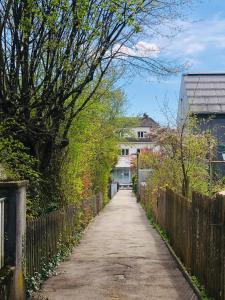 a dirt road with a fence and a house at Buddha-Loft in Solothurn