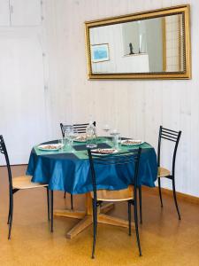 a table with chairs and a blue table cloth at Buddha-Loft in Solothurn