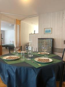 a table with plates and glasses on a blue table cloth at Buddha-Loft in Solothurn +7 photos