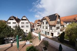 a group of buildings with solar panels on the roofs at Hotel Baeren in Leimen