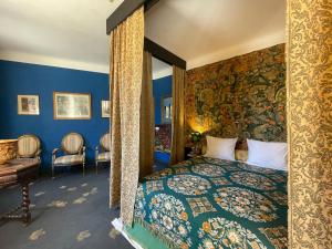 a bedroom with a king sized bed with blue walls at Oranienburg Vintage Hotel - Private Garden Residence in Vianden