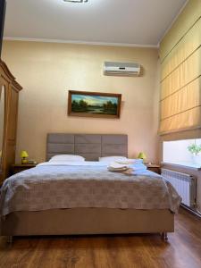 a bedroom with a large bed in a room at Bazar Apartment in Chişinău