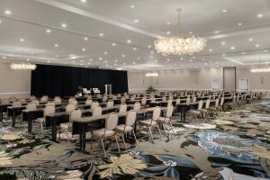 a conference room with tables and chairs and a chandelier at Hotel Mockingbird, Dallas, a Tribute Portfolio Hotel in Dallas +31 photos