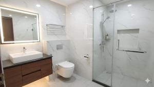 a bathroom with a shower and a toilet and a sink at Hotel DSR Park Near igi Airport Delhi in Majhera +21 photos