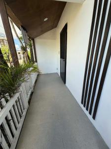 a hallway leading to a door in a building at Pinkys Guest House in Allen +2 photos