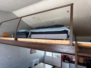 a bedroom with a bunk bed on top of a ladder at Charmante maison vue chenal in Les Sables-d'Olonne
