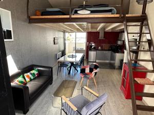 a living room and dining room with a loft bed at Charmante maison vue chenal in Les Sables-d'Olonne