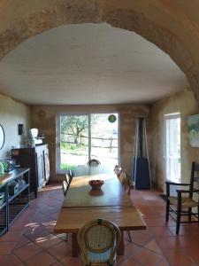 a dining room with a wooden table and chairs at Chambres d'hôtes Mas Lassagne in Vagnas