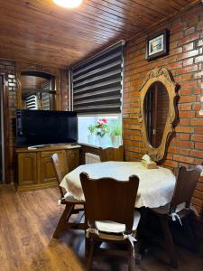 a dining room with a table and chairs and a mirror at Bazar Apartment in Chişinău