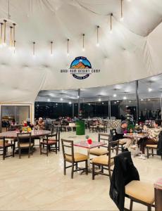 a dining area with tables and chairs in a tent at WADl RUM DESERT CAMP in Wadi Rum