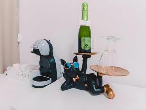 a figurine of a cat sitting next to a bottle of wine at La tana del Furlo in Acqualagna