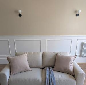 a white couch with pillows in a living room at Modern Flat - Main St, Campbeltown in Campbeltown