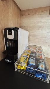 a box of food sitting on a table next to a coffee maker at Hipo camp Mobil home Arta in Pakoštane