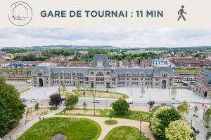 an image of a large building in a city at Le Nid Fleuri - Séjour familial à Tournai in Tournai