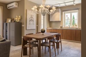 a kitchen and dining room with a table and chairs at Villa Natalie in Vabriga
