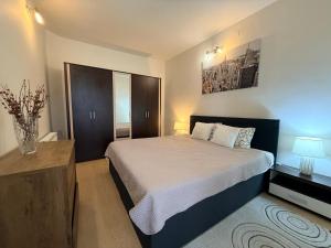 a bedroom with a bed and a vase of flowers at Moon Stylish -FREE parking -Romantic City Stay in Timişoara