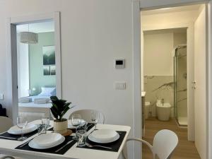 a dining room with a table and chairs and a bedroom at Bressanone Apartments in Milan +214 photos