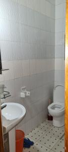 a bathroom with a sink and a toilet at Bati Valley Guest House in Kigali +57 photos