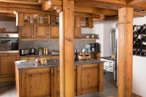 a kitchen with wooden cabinets and a counter top at Chalet am Frohmarkt in Oberstdorf