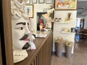 a statue of a woman on a counter in a salon at Hotel Soleado in Taormina
