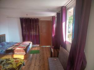 a bedroom with a bed and a window at The Devine homestay in Ukhimath